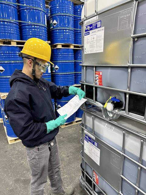 Worker inspecting hazmat storage at a 3PL warehouse near New York City